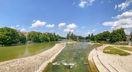 Riverside in Munich with bridge "Wittelsbacherbrücke" across the Isar River and view to museum "Deutsches Museum" in summer, Bavaria Germany Europe