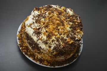 A very festive, delicious, New Year's cake with honey layers, called Honey cake located on a dark background.