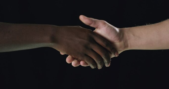 People, interracial and handshake for partnership, greeting or welcome on a dark background. Closeup of person shaking hands for teamwork, unity or thank you together in collaboration on mockup space