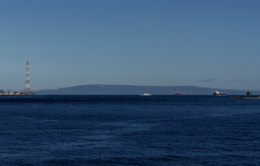 Fototapeta premium view of the narrow Strait of Messina between Sicily and mainland Italy and ships passing