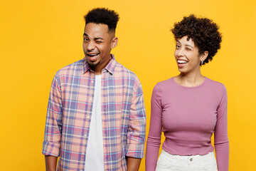 Young cheerful fun smiling couple two friend family man woman of African American ethnicity wears...