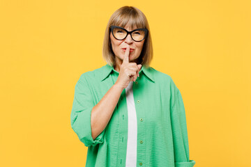 Elderly blonde woman 50s years old she wear green shirt glasses casual clothes say hush be quiet...