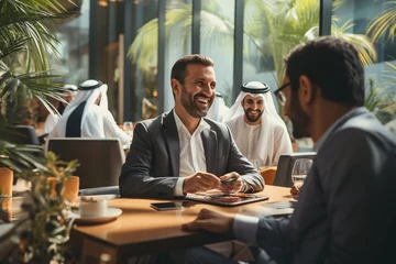 Crédence de cuisine en verre imprimé Dubai Middle-eastern executives in traditional Emirati attire holding a meeting in Dubai's office - UAE business team collaborating and generating ideas.