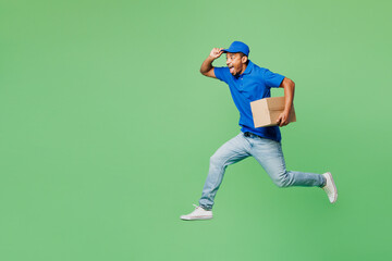 Full body fun delivery guy employee man wear blue cap t-shirt uniform workwear work as dealer...