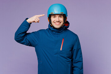 Skier smiling cheerful happy man wear warm blue windbreaker jacket ski goggles mask point index...