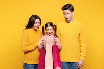 Young shocked parents mom dad with child kid girl 7-8 years old wear pink sweater casual clothes...
