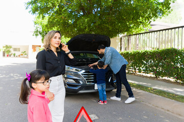 Stressed parents ith kids having problems with the car