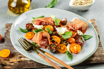 antipasto tomato salad with Prosciutto, ham jamon, tomatoes, cheese. banner, menu, recipe place for...