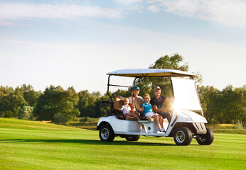 Beautiful family portrait in a cart at the golf course