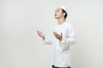 asian muslim man with praying hand gesture. holding palm face up. People religious Islam lifestyle concept. celebration Ramadan and ied Mubarak. on isolated background.