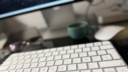 Home workspace with computer and coffee cup