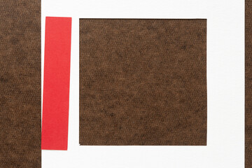 white mat frame and red stripe on dark brown board