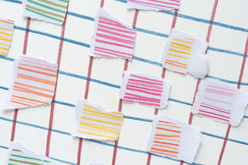 torn paper tiles with colored pencil lines on paper covered with lines