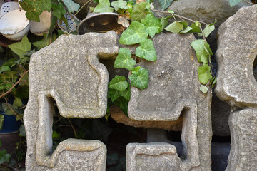 Stone old antique wall decor statue in the garden