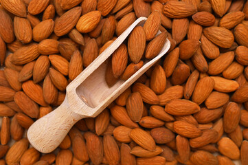 wooden scoop with almonds close-up