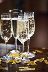Champagne Flutes In Golden Sparkle Background with golden confetti