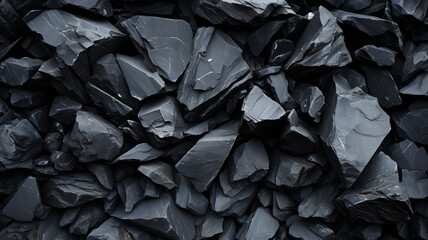 Sharp black rocks, slate shards, dark slate stones with sharp angles, pebble, gravel background texture, black and white