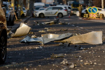 KYIV, UKRAINE - 20231229: Debris lies in the middle of the street, in the background police cars have blocked the street in Kyiv