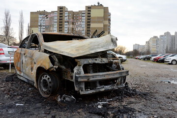 KYIV, UKRAINE - 20231229: Cars lie wrecked in the parking lot following a Russian missile strike on December