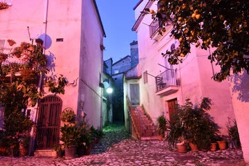 Fotobehang Smal steegje A narrow street between the old houses of Caiazzo, a medieval village in the province of Caserta, Italy.