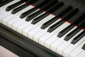 Naklejka premium Piano keyboard close-up, displaying the meticulous arrangement of alternating ebony and ivory keys, music instrument fundamental in classical, jazz and other genres, due to its versatile sounds range