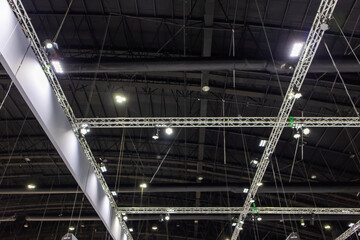 Structure of a truss steel building ,interior roof design and lighting - obrazy, fototapety, plakaty