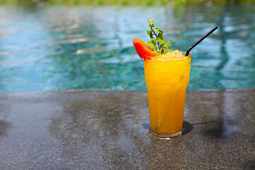 Cocktail Mai Tai with Light rum, dark rum, Orange Curacao, almond syrup, lime, ice cubes, pineapple and mint by the pool