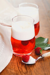 Delicious raspberry dessert in glasses on wooden table