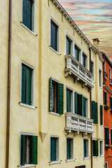 Fototapeta na wymiar Windows in Venice. Architecture. Wooden door and windows, building exterior in Venice, exterior design
