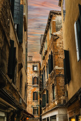 Fototapeta premium Facades of weathered buildings with windows on street of Venice city