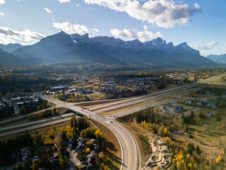 Aerial view of Trans-Canada Highway (Highway 1) exit 89 to Downtown Canmore in Canadian Rockies in a autumn sunny day. Alberta, Canada. Transportation concept.