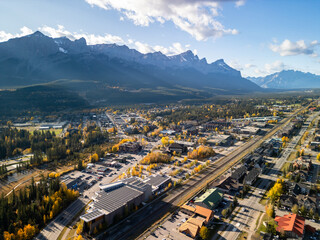 Aerial view of Town of Canmore in a autumn sunny day. Canadian Rockies mountain range in the...