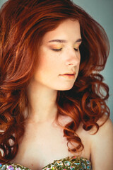 Beautiful young redhead woman with freckles portrait