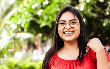 Young hispanic woman smiling wearing goggles outdoor with copy space