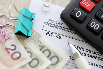 Annual calculation of tax on income obtained by taxpayer, PIT-40 tax forms on accountant table with...