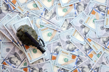 Grenade with a check against the background of huge amount of american dollar bills close up