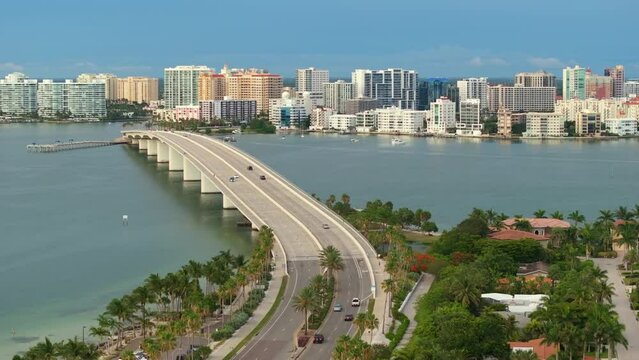Aerial view of Sarasota city downtown with Ringling Bridge and high-rise office buildings on horizon. Real estate development in Florida. USA travel destination