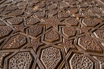 Detailed decorative engravements on the old wooden gate of the Grand Mosque in Yazd, Iran