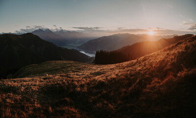 Mountain landscape in Zell am See with lake and Kitzsteinhorn at sunset, Salzburg Land, Austria - 701111895