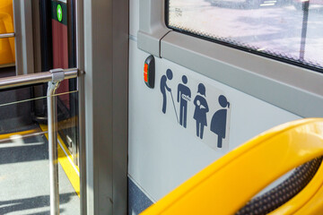 Promoting Inclusive Urban Mobility: A Detailed View of Priority Seating Icons in a City Bus...