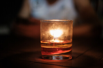 Lit Candle in Small Cup