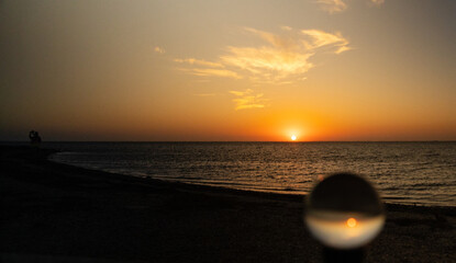 Orange sun just after sunrise over the beach on North Padre Island National Seashore in Texas....