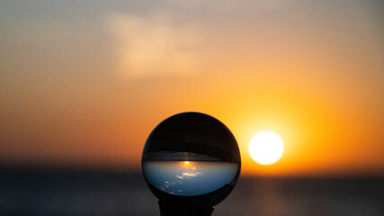 Crystal Ball on the beach reflecting the orange, yellow sunrise over the beach on North Padre...