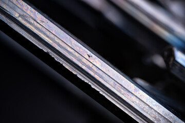 Stibnite (antimonite) blade macro photography detail texture background. close-up raw rough...