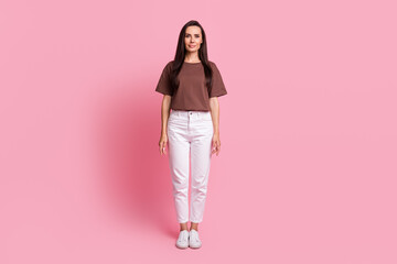 Full size portrait of attractive positive girl standing posing empty space advert isolated on pink color background