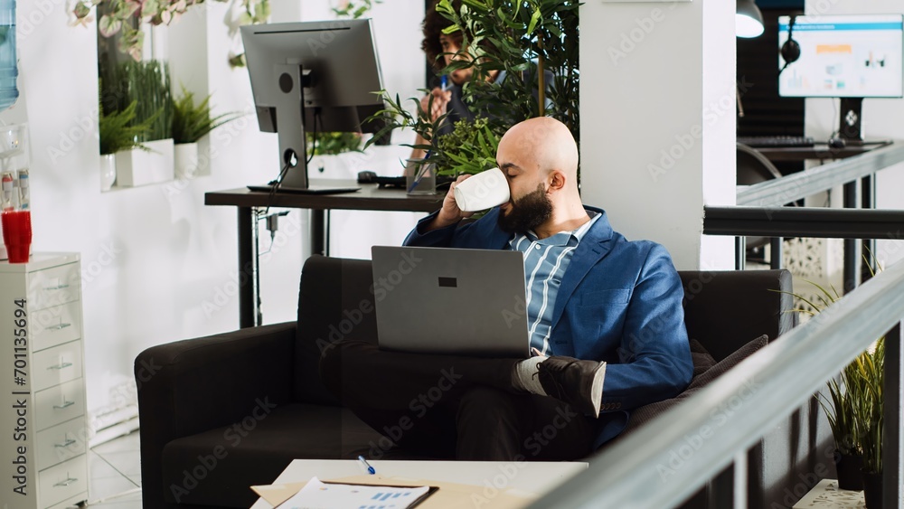 Aufkleber business manager reviews analytics, examining annual results on online documents in coworking space.
