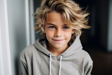 Portrait of a cute little boy with blond hair looking at camera