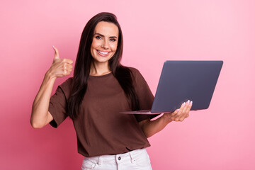 Portrait of young brunette hair female in brown t shirt demonstrate thumb up likes ms office...