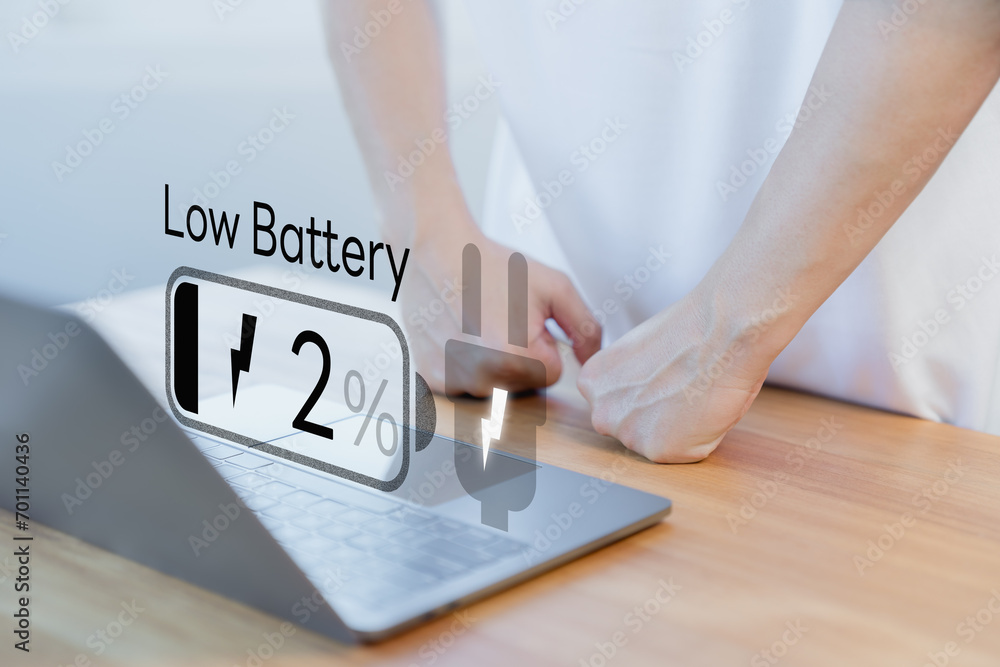 Poster Laptop out of battery. Concept of Technology and daily life. Man is angry and frustrated when he learns that his laptop computer's battery is dead and did not bring the charger adapter.