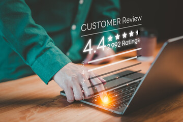 Customer using a computer laptop give ratings and point 4.4 stars icon for feedback review...